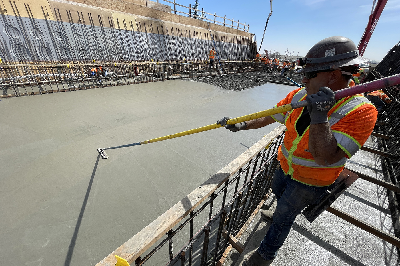 Worker smoothing concrete at Kimberlina viaduct.