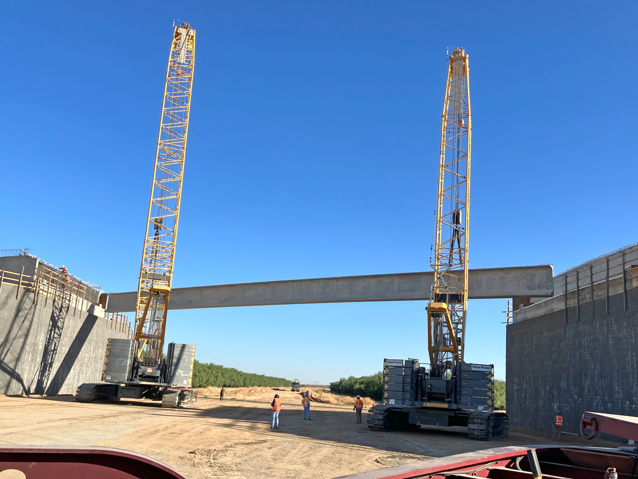 Crews from Tutor-Perini/Zachry/Parsons Joint Venture placing pre-cast girders at the Avenue 9 Grade Separation in Fresno County. Each girder spanned 172-feet long, is 7 feet tall and weighed more than 210,100 pounds. This is the first four of nine girders to be placed at the Avenue 9 overcrossing.