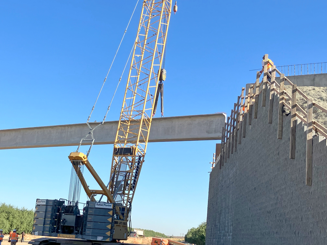 Crews from Tutor-Perini/Zachry/Parsons Joint Venture placing pre-cast girders at the Avenue 9 Grade Separation in Fresno County. Each girder spanned 172-feet long, is 7 feet tall and weighed more than 210,100 pounds. This is the first four of nine girders to be placed at the Avenue 9 overcrossing.